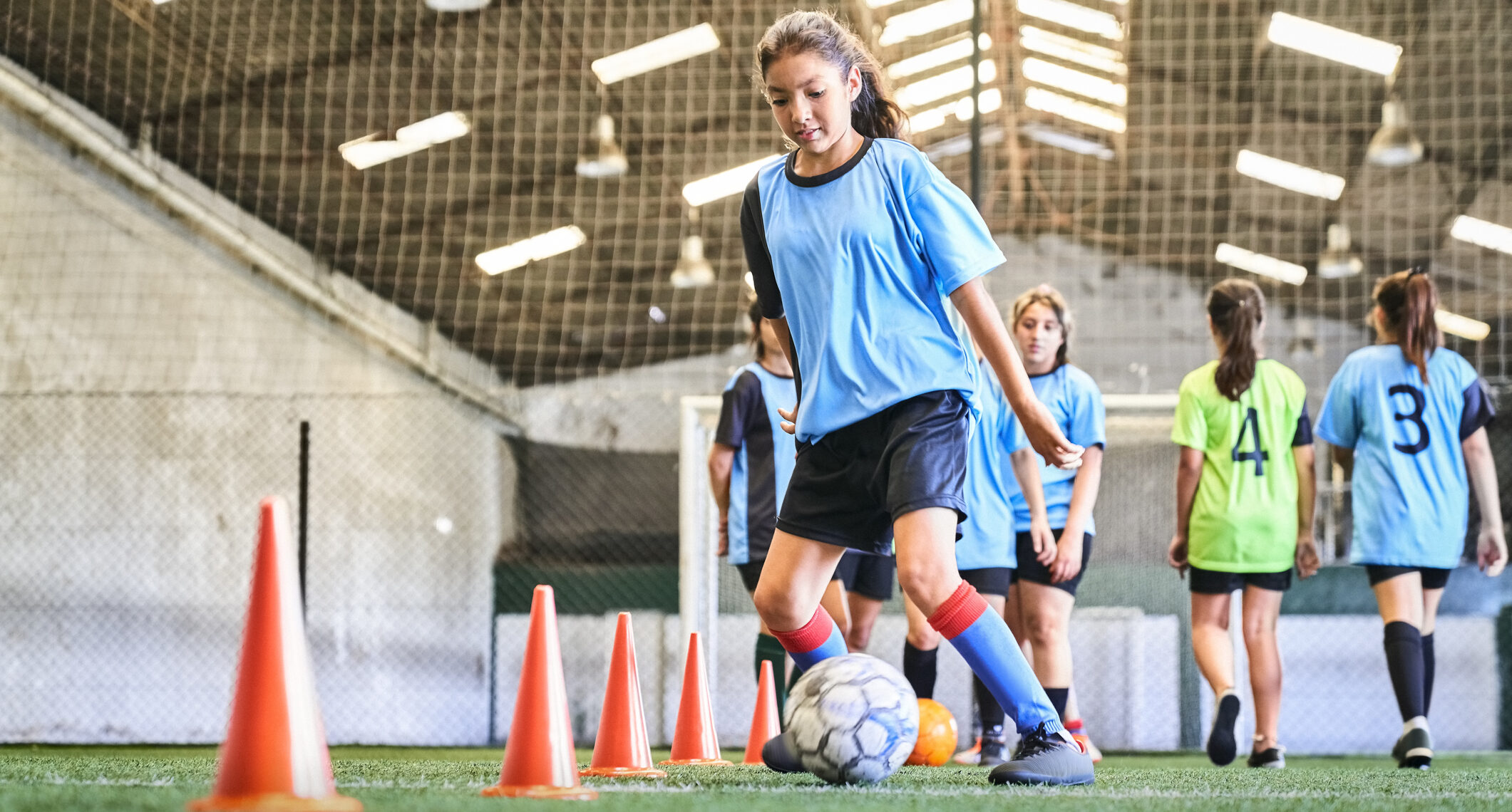 Confident Female Soccer Player Practicing Skills At Court
